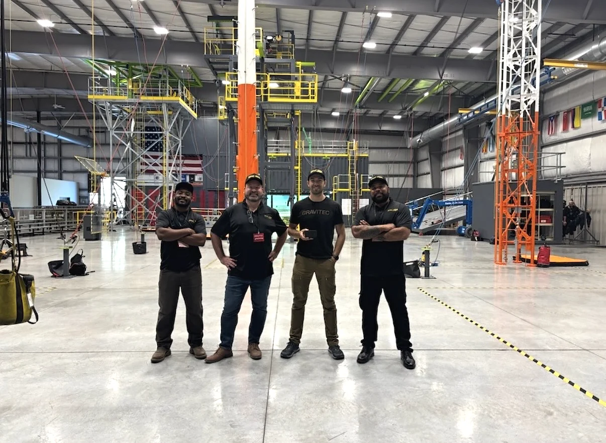 Epic Global Innovations and Gravitec Systems personnel inside a professional fall-protection testing facility.